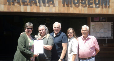 Group of people outside Talana Museum holding an Eskom account.