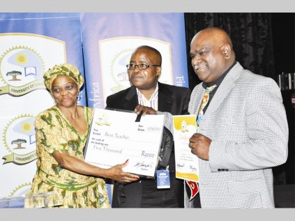 Thakane Matla (assistant registrar; committee relations) and Dr Abbey Ngoepe (director: quality assurance) present Dr Suresh Singh with the best lecturer award in the faculty of humanities at the University of Limpopo.