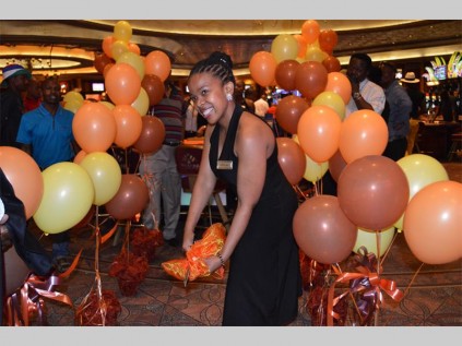 Refilwe Tlhabanyane (Meropa Casino and Entertainment World, marketing manager) cuts the ribbon to officially opens the new black jack table, Dealer Bust 21.