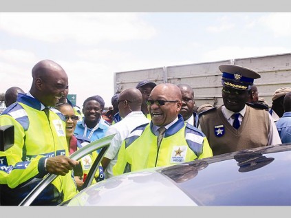President Jacob Zuma and the Polokwane mayor Freddy Greaver inspect a motorist's driver's license.