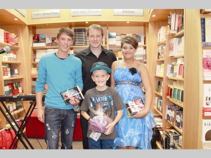 Johan Visagie (Cum Books, manager) congratulates the winners of Cum Books' talents show: Willem Venter (third), Dylan Posselt (winner) and Elize Venter (second).
