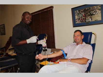 Johan Pieterse donates blood at the Mitchell House blood drive on Friday. He is assisted by Rhulani Maluleke from the SANBS.