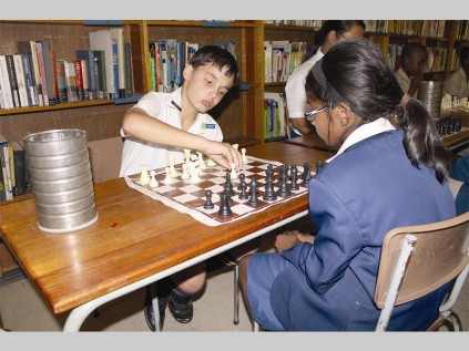Miguel Vilar from Pemps matches wits against Keren Benjamin from Mitchell House.