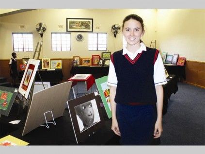 Lauren Lennox with one of her artworks at the Pepps Polokwane Preparatory School art exhibition last Wednesday.