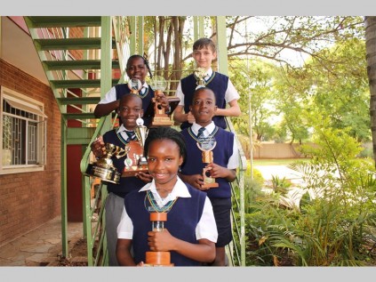 Jabez Christian School's primary school stars show off their awards. In front is Lavela Goldwana (Limpopo colours in modelling). In the middle are Olayiwola Fawole (mathematics 87%, character building 89% and Bible 82%) and Kamogelo Sebola (servanthood award). In the back are Pule Molepo (natural sciences 83% and social studies 91%) and Ricardo Erasmus (computer science 85%).