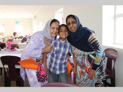 Muhammad Gatta poses with his grandmothers, Zohara Gatta and Aziza Bhamsee.