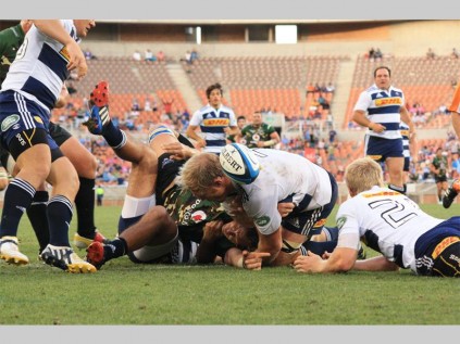 Vodacom Bulls flanker, Arno Botha scores his team's third try against the DHL Stormers during a Super Rugby warm-up match. Defending the ball are DHL Stormers' Damian de Allende (underneath Botha), Schalk Burger and Scott van Breda. The DHL Stormers won 26-19.