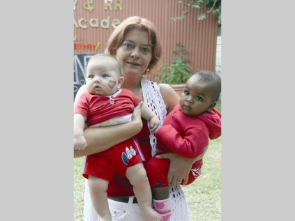 Even the babies at Bug's Paradise celebrate Valentine's Day: Jordan van der Linde and Lethabo Kolobe are held by their teacher, Martie van Schalkwyk.
