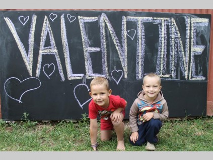 Shayden Erasmus and Henry Janse van Rensburg pose in front of Bug's Paradise's Valentine's Day sign.
