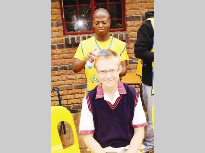 Noko Rashedu sprays Jancu de Klerk's hair during the Cansa Shavathon at Pepps Polokwane College.