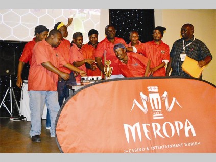 Members of the P.K. Casino Club celebrate their victory at the Meropa Casino and Entertainment World casino card game tournament.