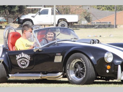 Philip Lottering sit agter die stuur van 'n AC Cobra by die Bosveld Autoklub se Cars in the Park-uitstalling. Langs hom is sy vrou, Lusinda.