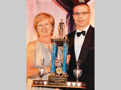 Jana Smith, outgoing president of the Soutpansberg Chamber of Commerce, hands over the local businessman of the year award to André Prinsloo of P&L Hardware.