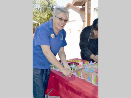 Zyrilla van der Kolff, the owner and principal of Aladdin's Den Pre-School cuts a specially baked cake during the school's 20th birthday celebration.