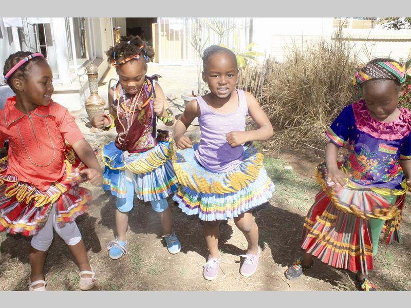 Khodani Mashiane, Gundo Nwedamutswe, Zizi Ngema and Sagwati Ngonyam show their friends a traditional African dance during Montessori Centre's Heritage Month celebrations.