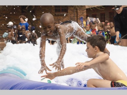 Damien Groenewald and Lesiba Choshi compete in a ball game during Pepps Polokwane Preparatory School's water fun day.