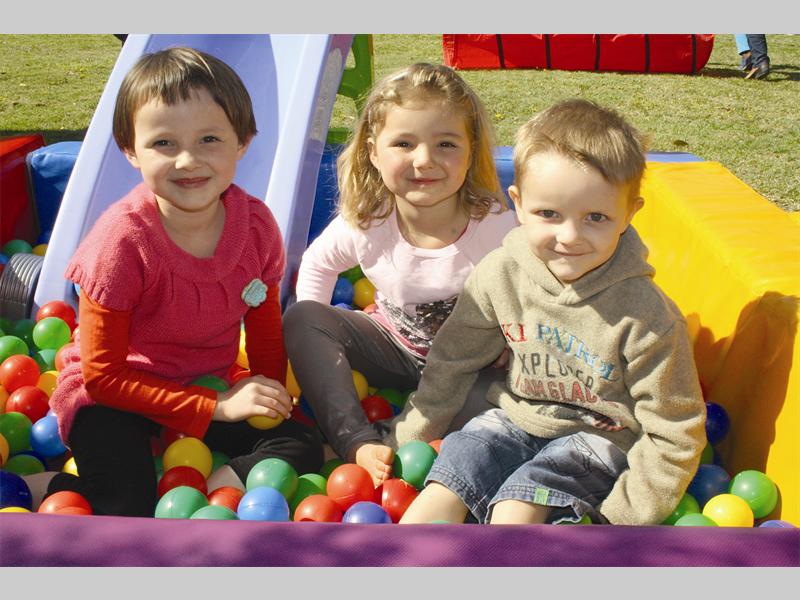 Nicole Krogh, Dederé Venter and Kevin Krogh play in a ball pit at the Mt Horeb Presbyterian Church fete.