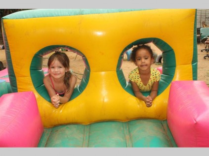 Demi Steyn and Berinike Bhimjee play on one of the jumping castle at the Gr. R and RR Academy year-end function.