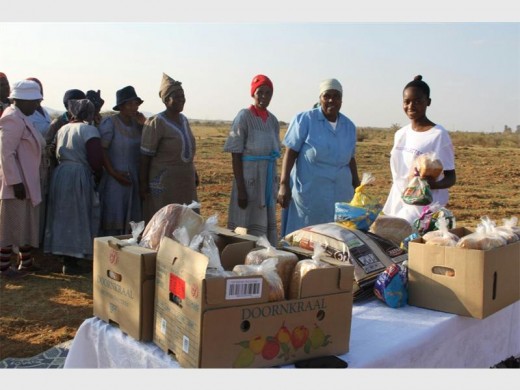Sukoluhle with residents of Ga-Mothapo Village where she handed out rice and bread to widows and disabled people.