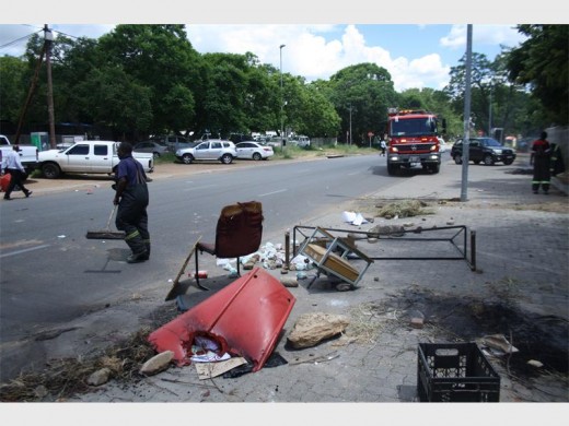 Bins, chairs and tables burned by angry parents in front of Department of Education offices.