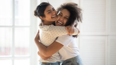 Happy Multiethnic Girlfriends Have Fun Hugging Indoors