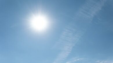 A photo of sun rays and a cloudy sky.