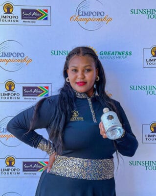 Bestina Rakgoale holds a bottle of her gin.