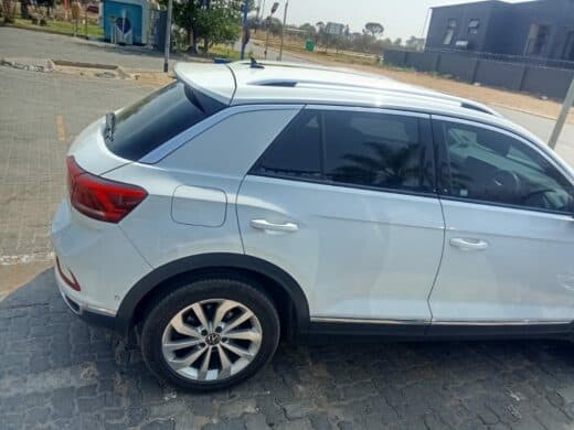 Photo of a white vehicle parked at a filling station.