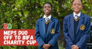 Two MEPS soccer players stand in their school uniforms.