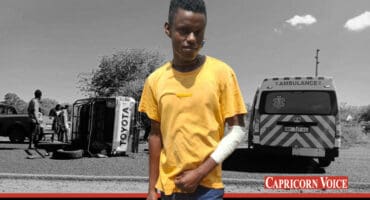 A player with a bandaged arm. Behind him, the scene of the crash.