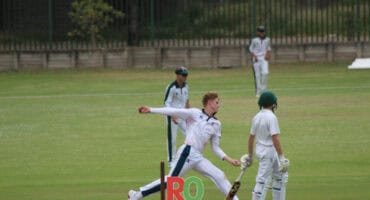 A cricket player bowls a delivery.