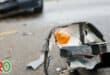 A headlight lies on the road after a collision.