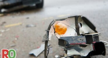 A headlight lies on the road after a collision.