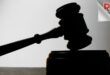 a judges' gavel resting on the gavel block