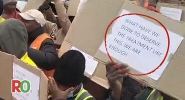 Residents during a protest hold up boards that read "What have we done to deserve this treatment, we are enough".