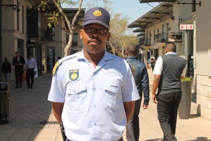Constable Michael Kagtla of Fairlad police station at the scene of a gun raiding attack.