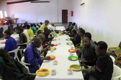 Unemployed men enjoying a meal at Christ the King church at Sophiatown.