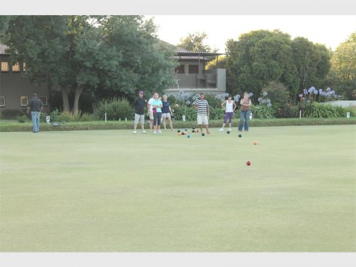 Players take part in an evening tournament of bowls.