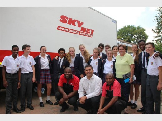 Diederick Stopforth and his Skynet Worldwide Express team with the eight-ton truck filled with water. Debbie Harris, principal of the College and pupils help load the truck. Photo supplied.