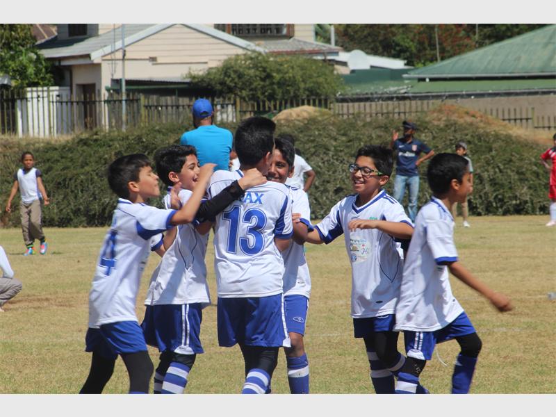 Auckland Park Academy of Excellence celebrate after scoring a goal.