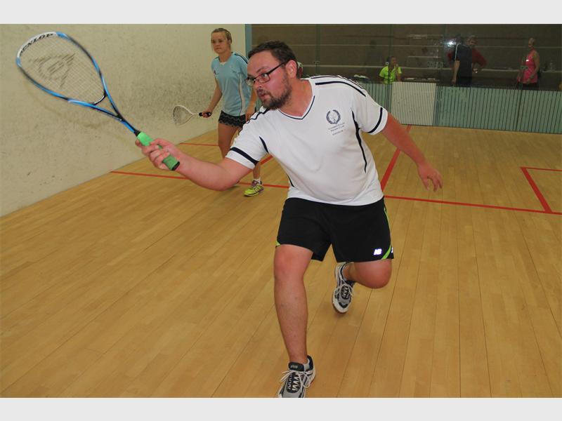 Andrew Jensen runs hard to reach the ball in his game against Megan Shannon.