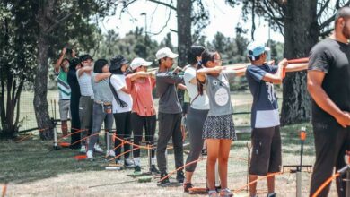 Archery students stand ready with their bows and arrows at Marks Park