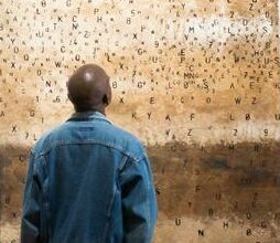Wezile Harmans looks at one of his art pieces.
