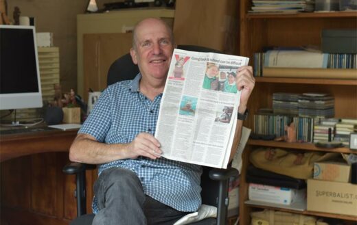 Gus Silber holds a copy of the Norhtcliff Melville Times