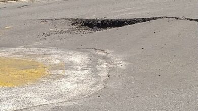 The road's surface can be seen to have split at two points around the traffic circle.