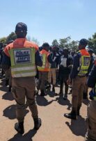 JMPD officers and mourners engaged in a vigorous discussion