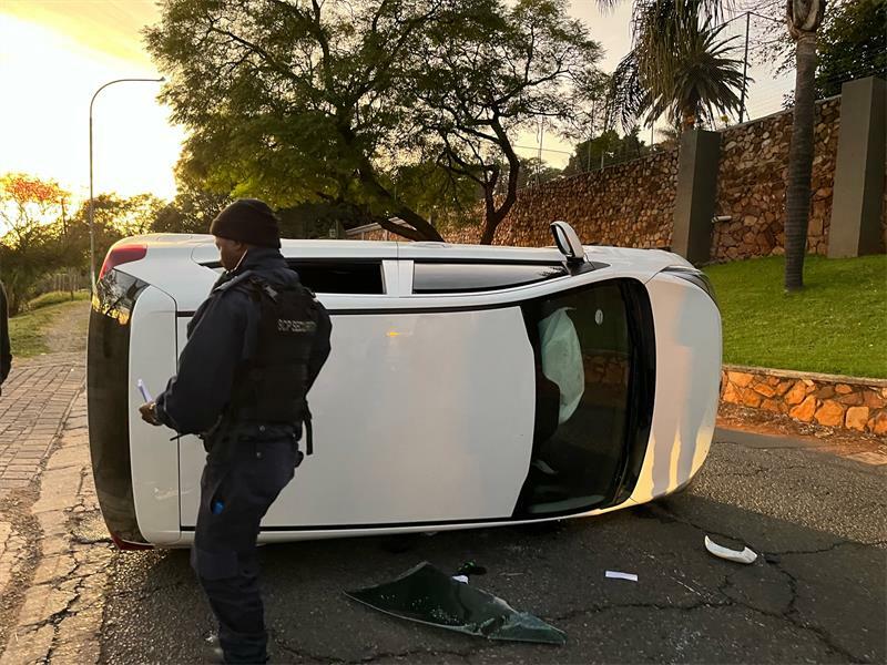 An SCP guard attends the scene where a vehicle flipped along Senior Drive in Northcliff.