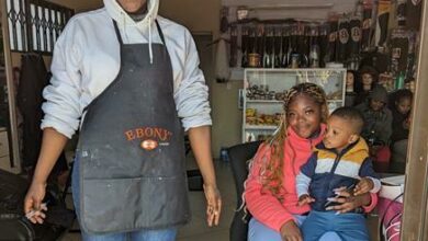 Tiwa Srri, Zanele Rivombo and Kyler Fafta at the doorway of Srri's beauty salon which can hardly open with the Rand Water maintenance water shutdown. Photo: Emily Wellman Bain.