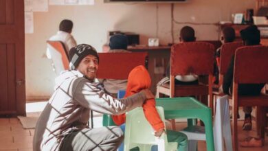 Larnell Mann at the daycare centre with some of the children. Photo: Neo Phashe
