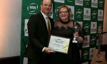 Avbob CEO Carl van der Riet presents Northcliff Melville Times editor Aimee McGill with the award for Newspaper of the Year at the annual Avbob FCJ Awards.